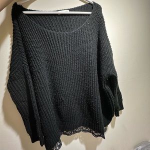 Black knit sweater with lace trim on the bottom